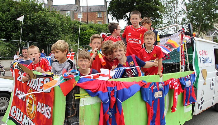 Group of children on a football themes float taking part in the Gwyl Felin procession