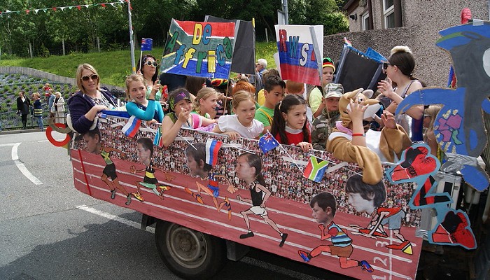 children sitting on a float they made
