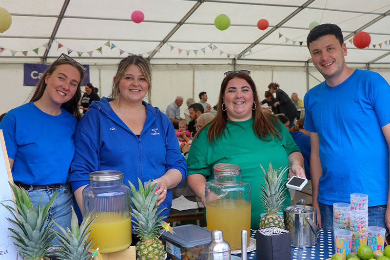 Committee members smiling during carnival day Gwyl Felin