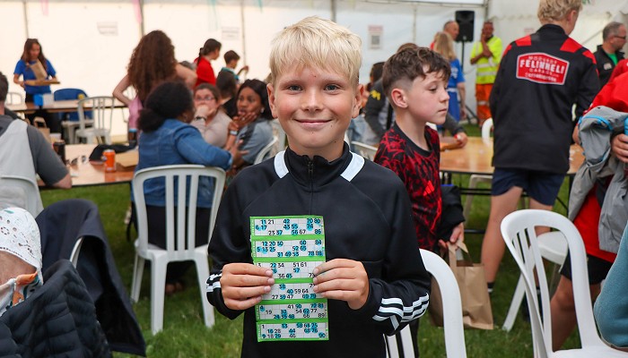 boy holding the winning bingo card