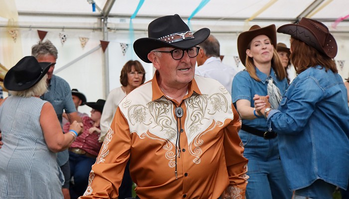 Country dancing in a decorated marquee.