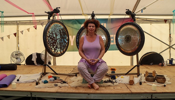 Leusa sitting in front of her Gong instruments