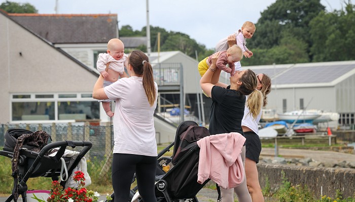 3 Mums holding their baby in the air while exercising