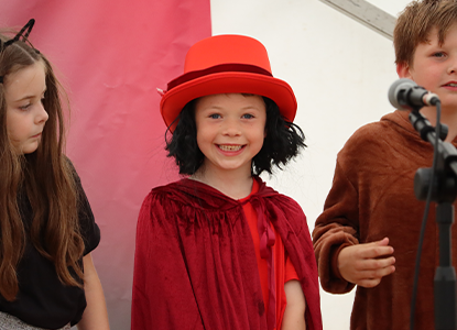 student dresses up on stage